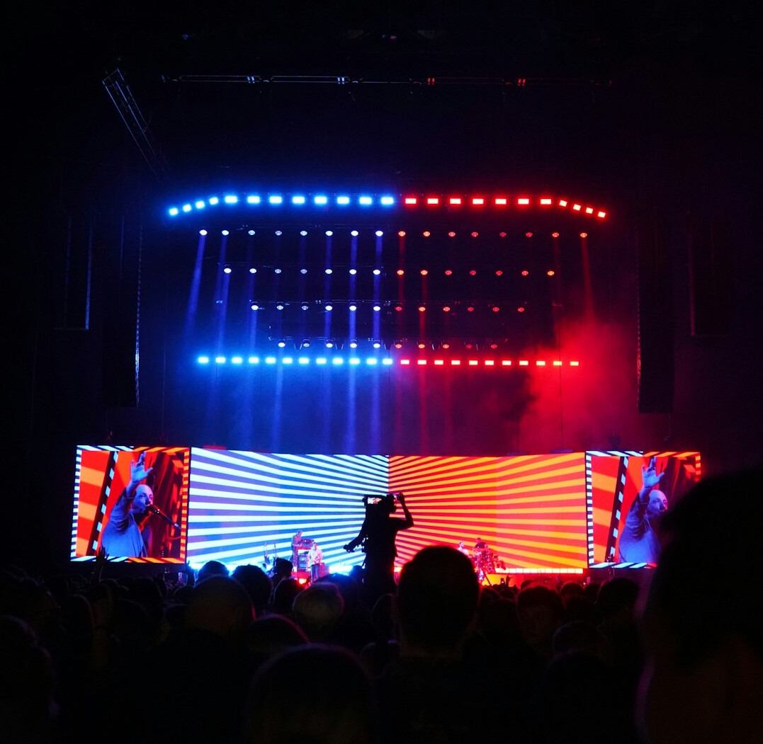 Live show stage with coloured lights and audience